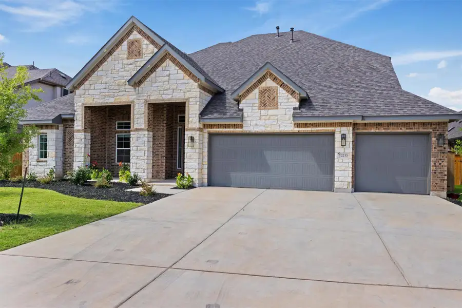 Front exterior of a new home in Palmera Ridge, Leander, TX, highlighting curb appeal (Image 31). Front exterior of a new home in Palmera Ridge, Leander, TX, highlighting curb appeal (Image 31).