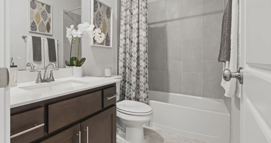 Representative furnished interior of a home built from the Avril by Chesmar Homes in Stream Waters, Buda (Image 24).