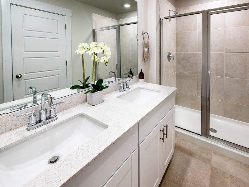 The primary bath offers a large walk-in shower. Photography from City Station Townes. The primary bath offers a large walk-in shower. Photography from City Station Townes.