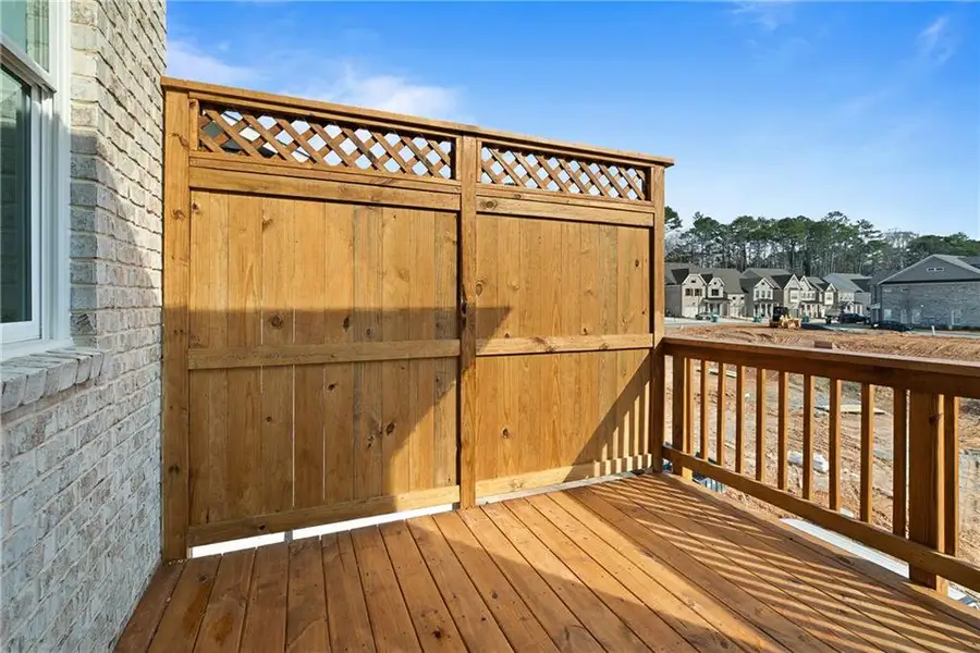 Exterior details and patio area of a home in Ward's Crossing Townhomes, Johns Creek (Image 3).