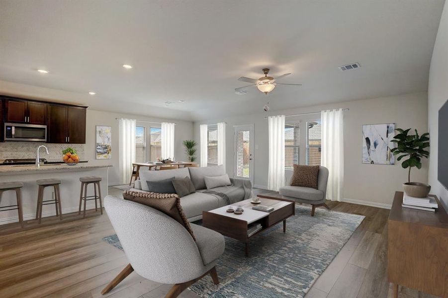 Living room with hardwood / wood-style flooring, sink, and ceiling fan