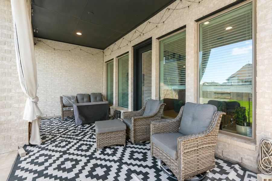 Inviting covered patio perfect for relaxing, outdoor dining, and enjoying the backyard year-round