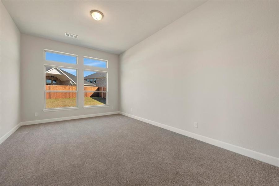 Empty room featuring baseboards and carpet