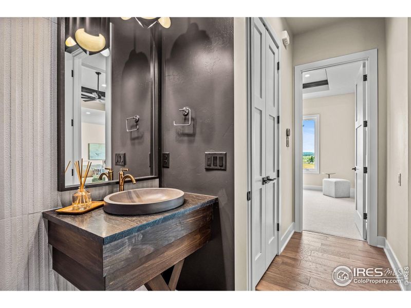 Dark accents in the powder room make the space pop