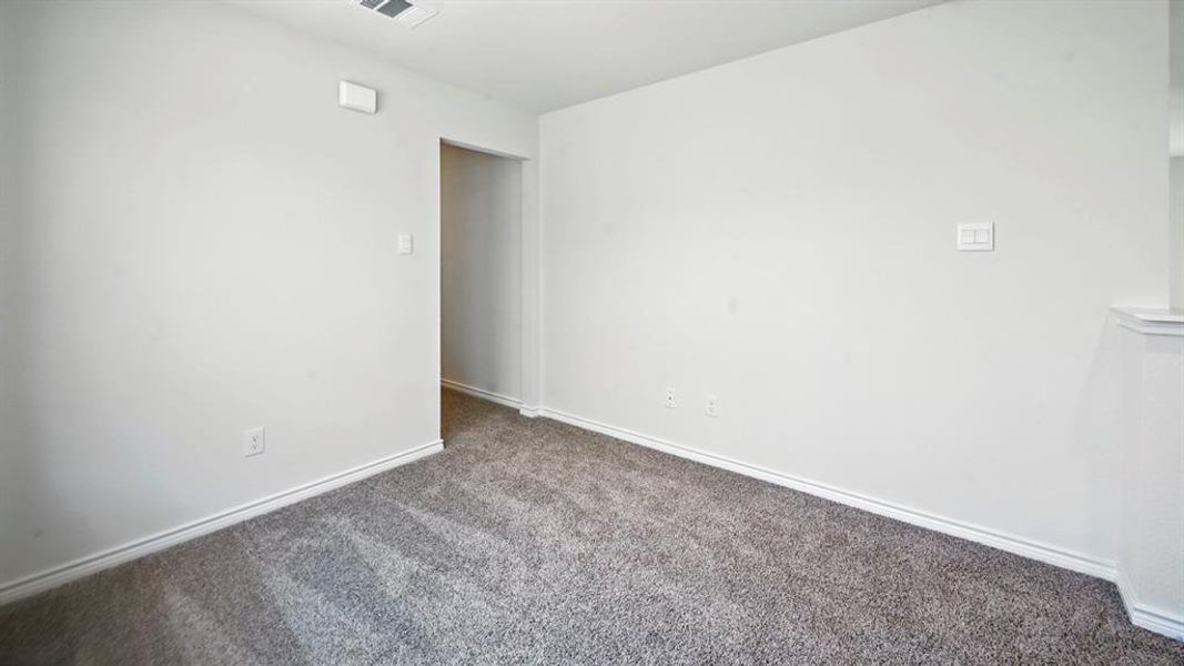 Carpeted spare room with baseboards