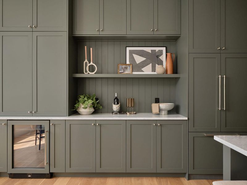Bar area featuring beverage cooler, open shelves, gray cabinets, light stone counters, and light wood-type flooring Bar area featuring beverage cooler, open shelves, gray cabinets, light stone counters, and light wood-type flooring