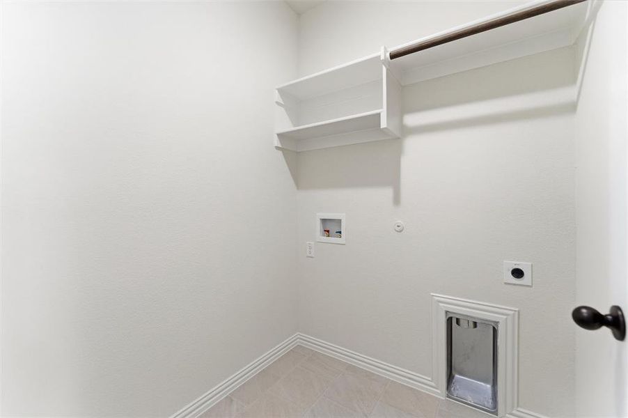 Laundry area with hookup for a gas dryer, electric dryer hookup, hookup for a washing machine, and light tile patterned floors