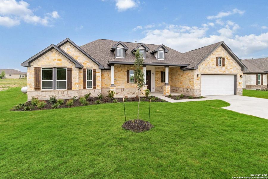 Front exterior of a new home in Jordan's Ranch, San Antonio, TX, highlighting curb appeal (Image 2).