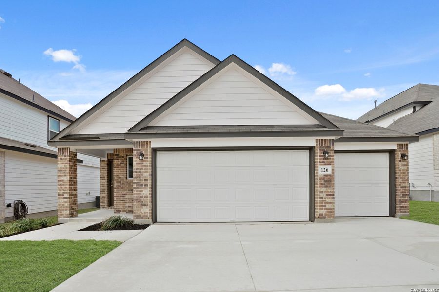 Front exterior of a new home in Hunters Ranch, San Antonio, TX, highlighting curb appeal (Image 1). Front exterior of a new home in Hunters Ranch, San Antonio, TX, highlighting curb appeal (Image 1).