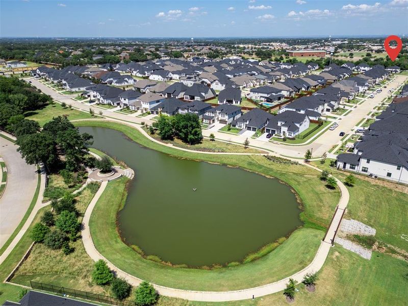 Aerial overview of property's location with a large body of water and nearby suburban area