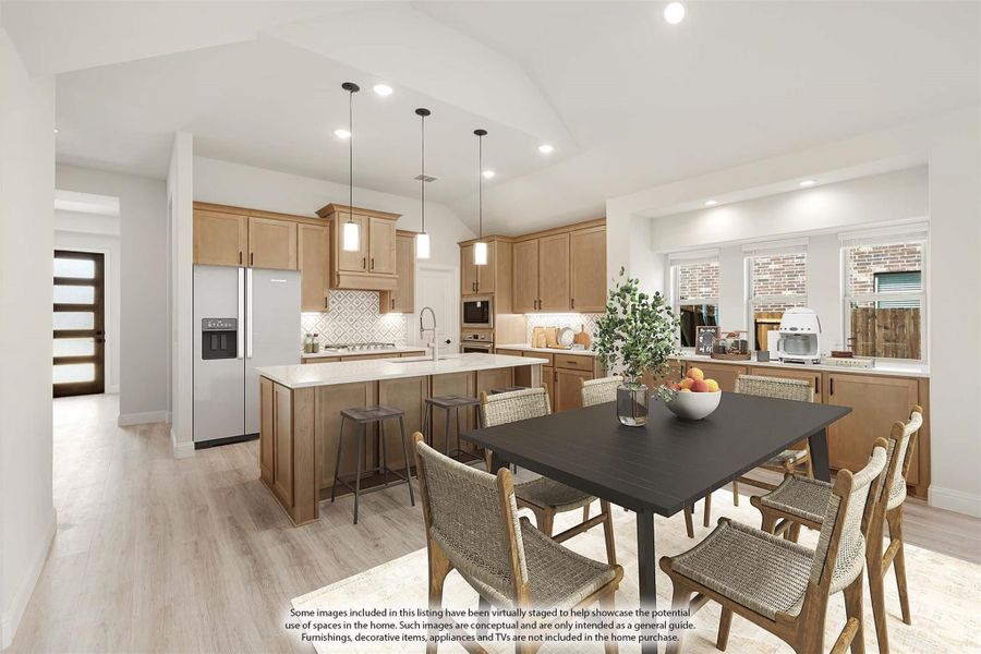 Open kitchen and dining area with light wood cabinets, center island, pendant lights, and vaulted ceiling