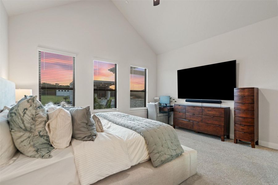 Restful primary bedroom features vaulted ceilings and ample natural light through well-placed windows. Restful primary bedroom features vaulted ceilings and ample natural light through well-placed windows.