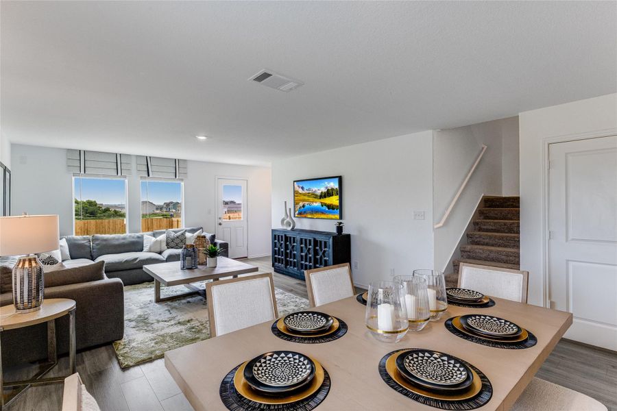 Dining area with stairs and wood finished floors Dining area with stairs and wood finished floors