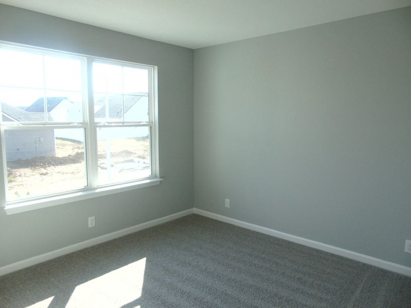 The second bedroom with large windows for that nature lighting, as well as your closet as well as a convenient rack.