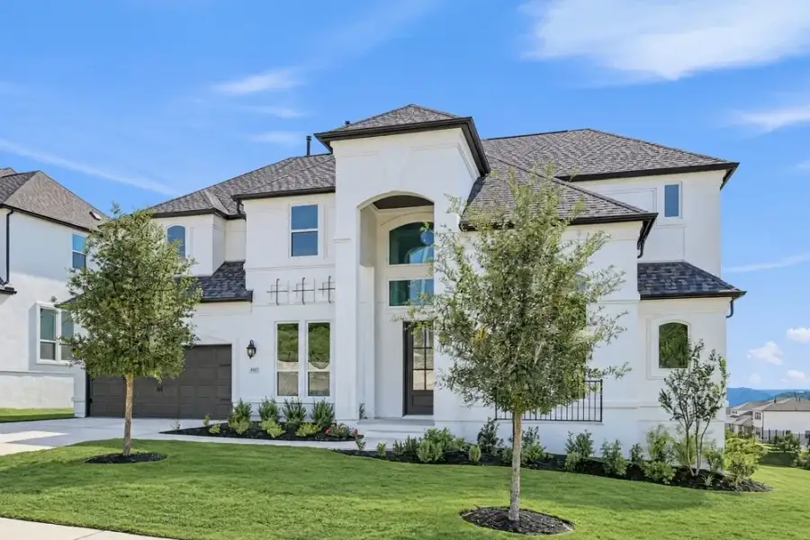 Front exterior of a new home in Travisso, Leander, TX, highlighting curb appeal (Image 16). Front exterior of a new home in Travisso, Leander, TX, highlighting curb appeal (Image 16).