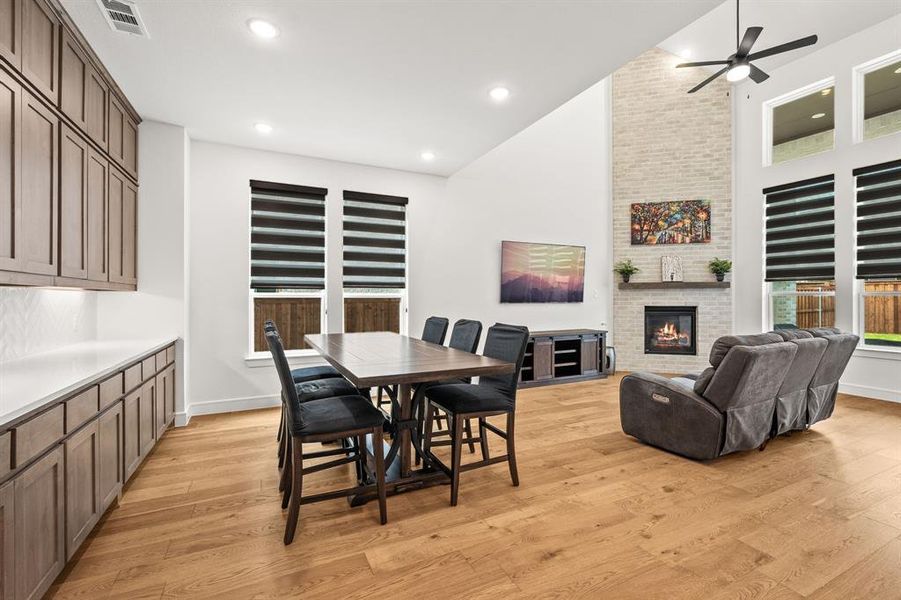 Dining space with light wood-style flooring, and tons of cabinets!