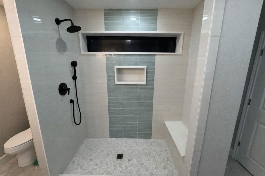 Primary bath with walk-in shower and seat.
