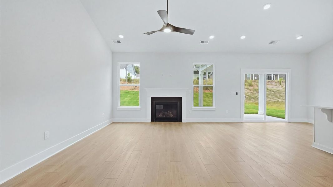 First-rate family room with thoughtful layout and superior connection to kitchen and dining spaces at Creeks at Midway