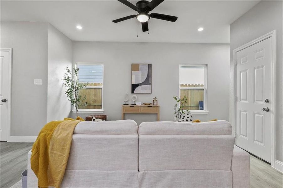 Living room featuring light hardwood / wood-style floors and ceiling fan