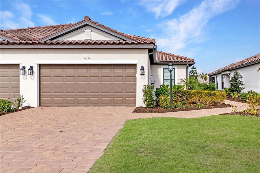 Front exterior of a new home in , Lakewood Ranch, FL, highlighting curb appeal (Image 20).
