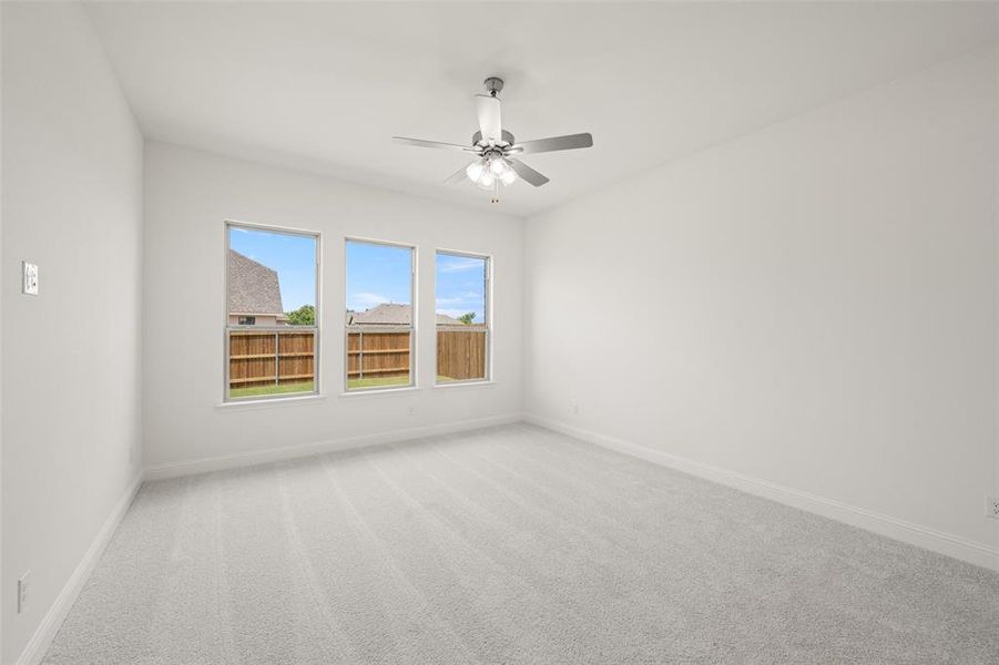 Unfurnished room featuring light colored carpet and ceiling fan Unfurnished room featuring light colored carpet and ceiling fan