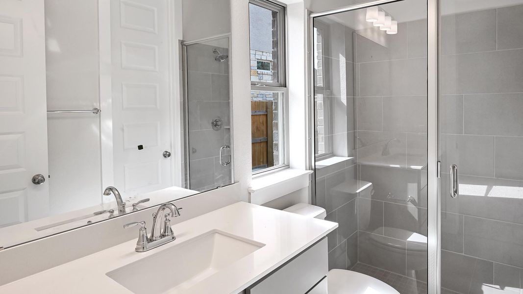 Full bath with vanity and a stall shower Full bath with vanity and a stall shower