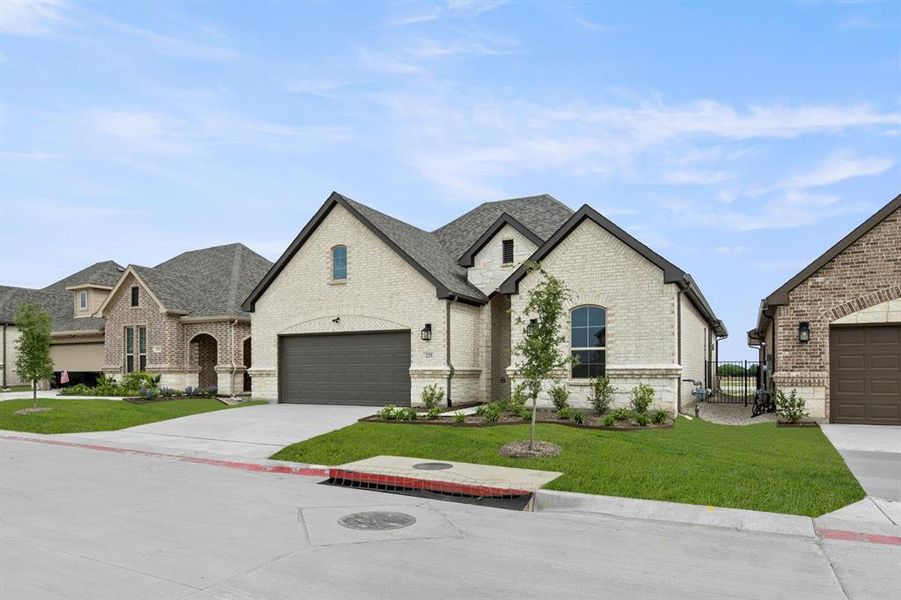 Front exterior of a new home in Ladera at Timberbrook, Justin, TX, highlighting curb appeal (Image 1). Front exterior of a new home in Ladera at Timberbrook, Justin, TX, highlighting curb appeal (Image 1).