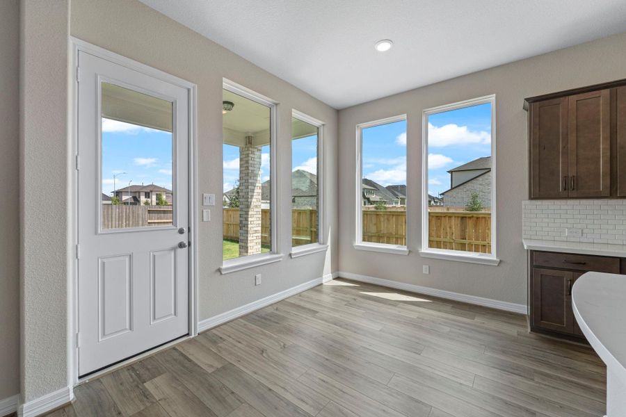 With an abundance of natural light streaming through the windows, the breakfast nook is bathed in a sunny glow, creating the perfect atmosphere to enjoy your morning coffee or a family breakfast. With an abundance of natural light streaming through the windows, the breakfast nook is bathed in a sunny glow, creating the perfect atmosphere to enjoy your morning coffee or a family breakfast.