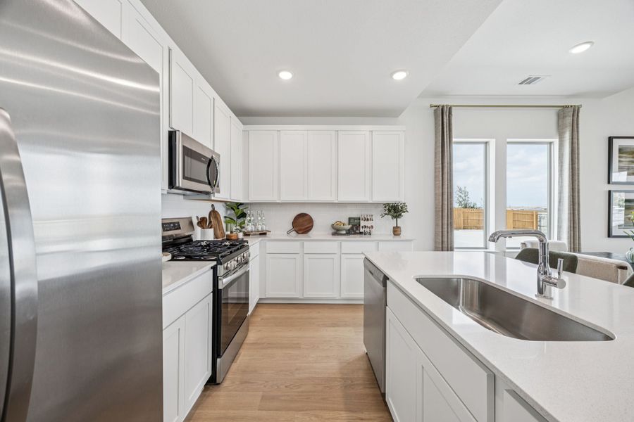 Kitchen in the Trinity home plan by Trophy Signature Homes – REPRESENTATIVE PHOTO