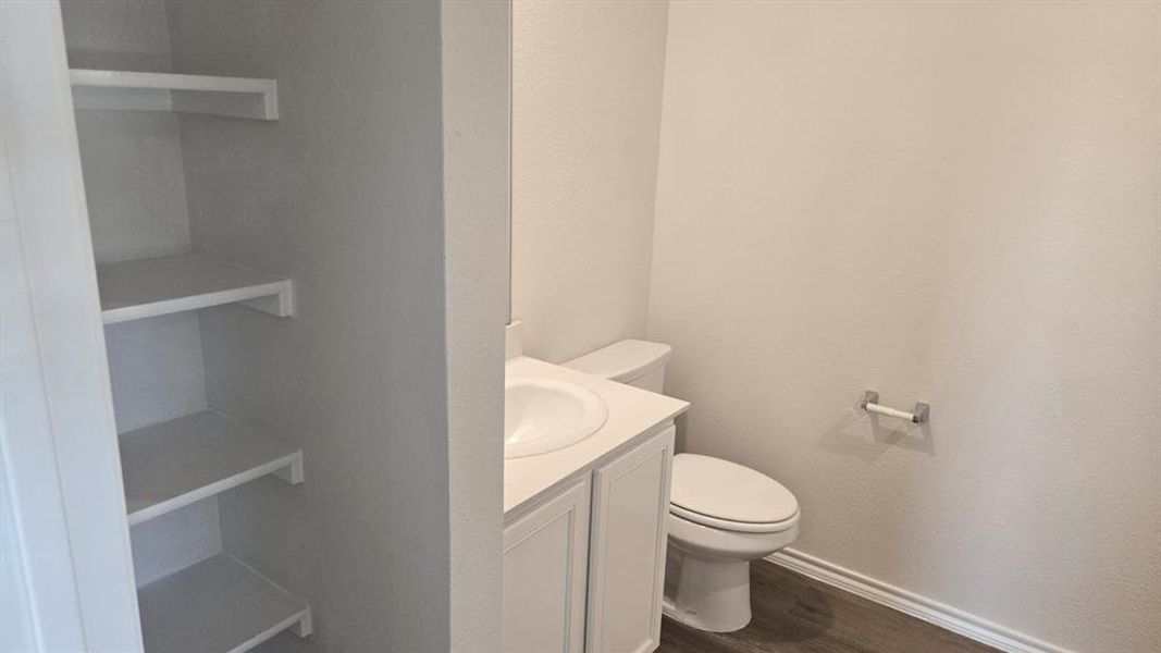 Bathroom featuring vanity and dark wood-style flooring