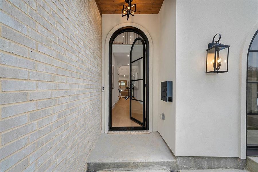 Entrance to property with stucco siding and brick siding Entrance to property with stucco siding and brick siding