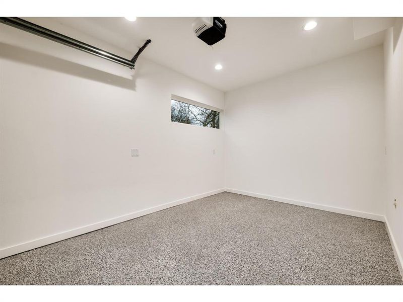 A fully enclosed garage, complete with durable and sleek epoxy flooring, offering a perfect blend of practicality and modern aesthetics.