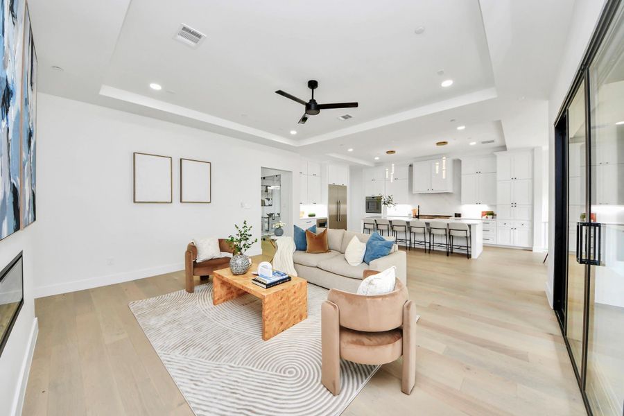 The living room seamlessly merges with the kitchen, forming a bright, open space where style and function unite for effortless daily living.