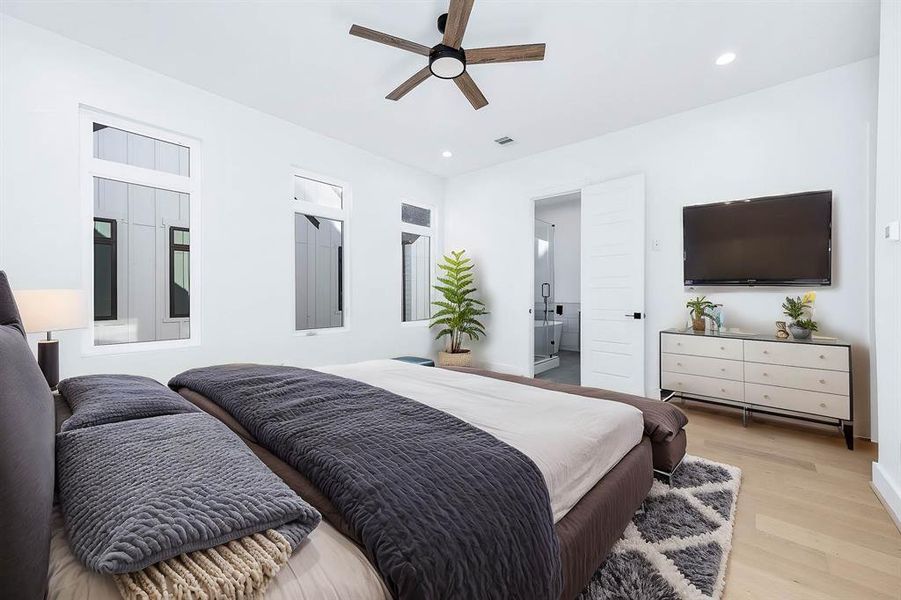 Large master bedroom with lots of natural lighting. Door straight ahead for the primary bathroom. This is virtually staged