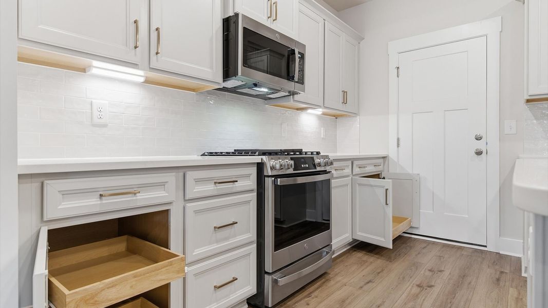 Tasteful kitchen with abundant storage and modern finishes in a first-class DRB Homes design Tasteful kitchen with abundant storage and modern finishes in a first-class DRB Homes design