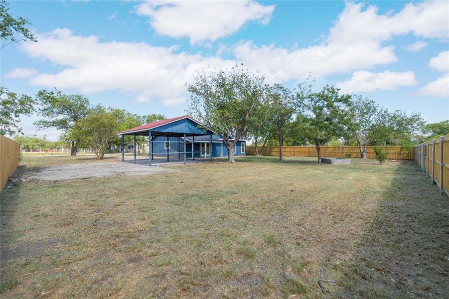 Fenced backyard with a carport and a patio Fenced backyard with a carport and a patio