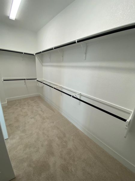 Walk-in closet in Primary Bedroom Walk-in closet in Primary Bedroom