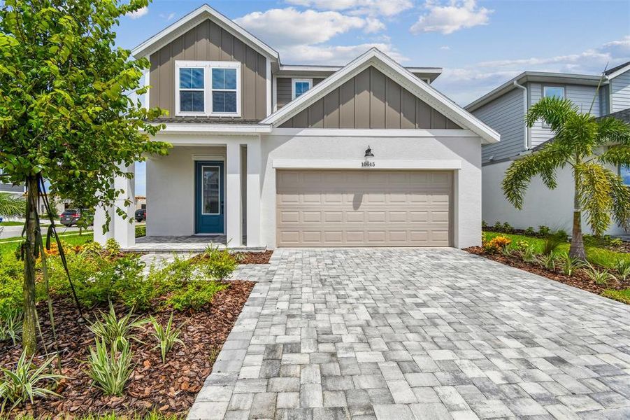 Front exterior of a new home in North River Ranch – Garden Series, Parrish, FL, highlighting curb appeal (Image 1).