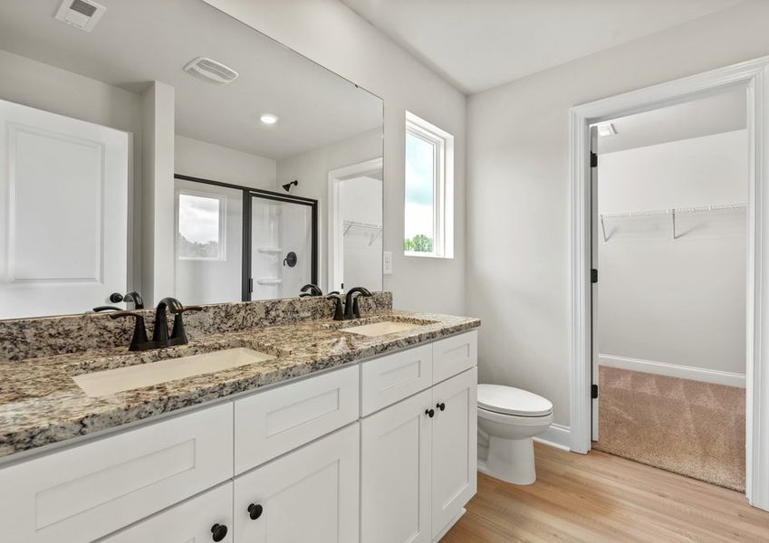 The master bathroom has a glass-enclosed shower