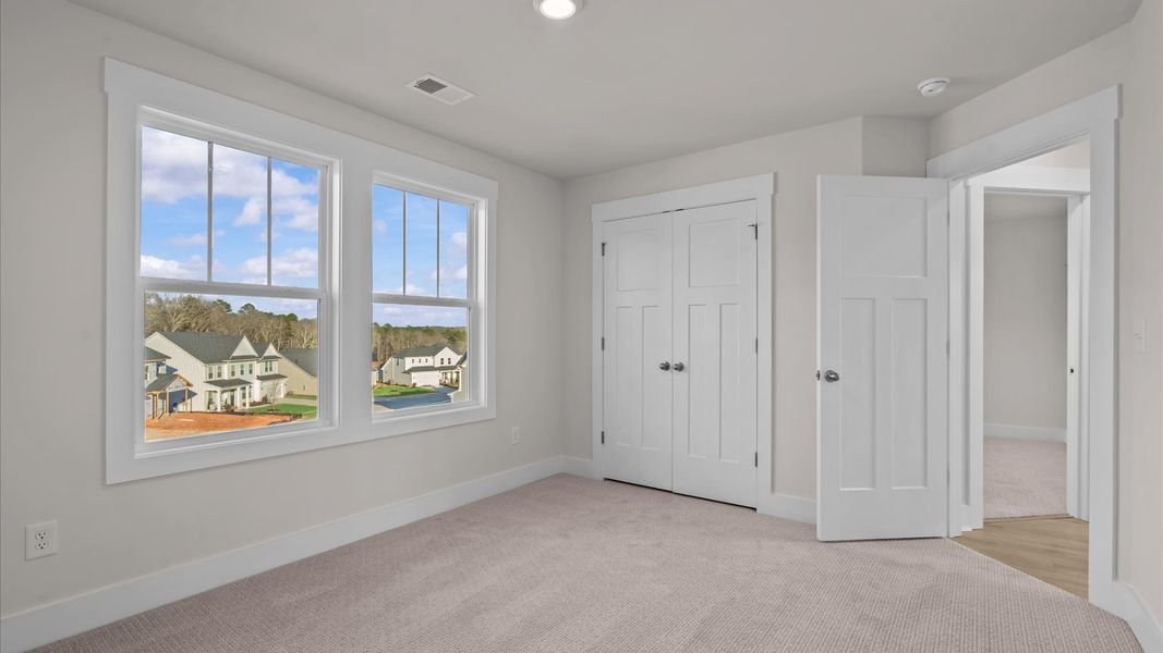 First-class bedroom with generous proportions, a walk-in closet, and beautiful natural light through large windows