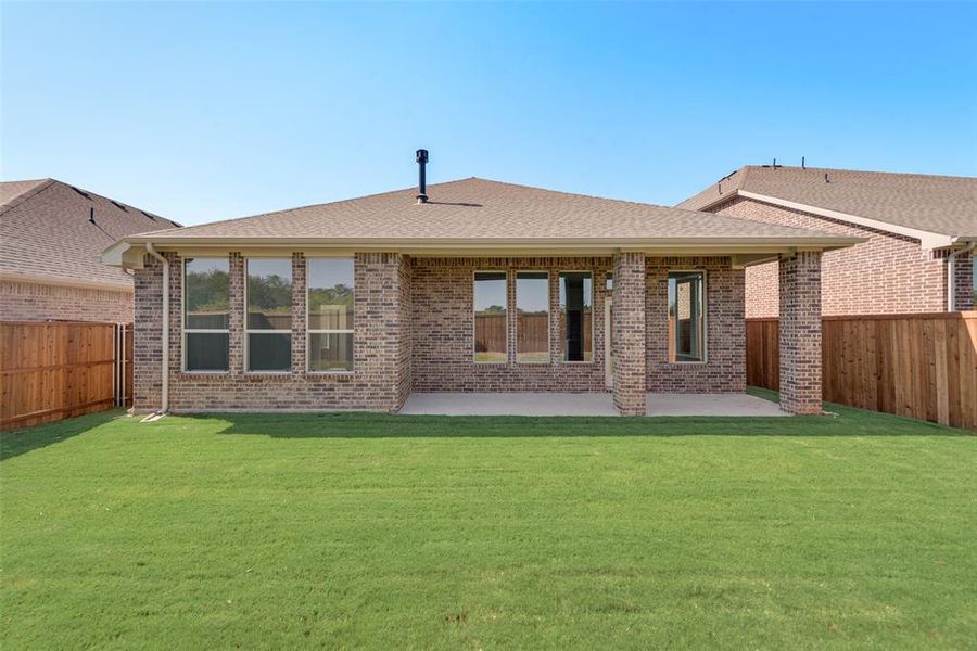 Back of property featuring a yard and a patio