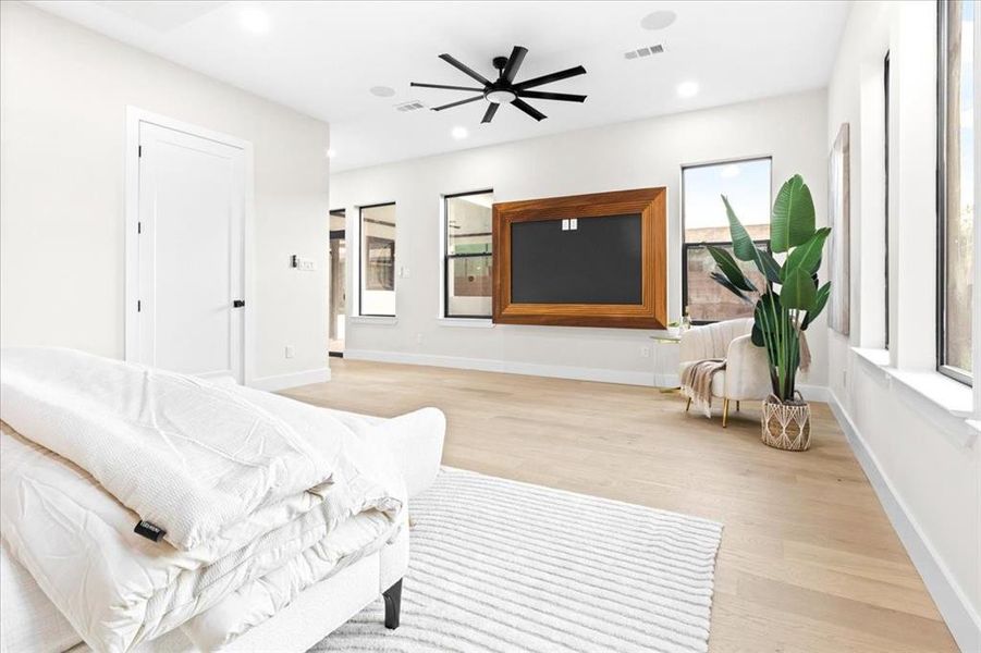 Living room with light wood-type flooring and ceiling fan