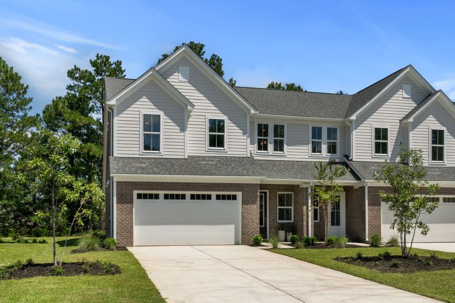 Front exterior of a new home in Long Bay Golf Club, Longs, SC, highlighting curb appeal (Image 1).