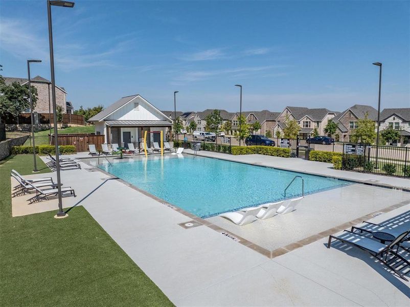 Community pool featuring a patio and a residential view Community pool featuring a patio and a residential view