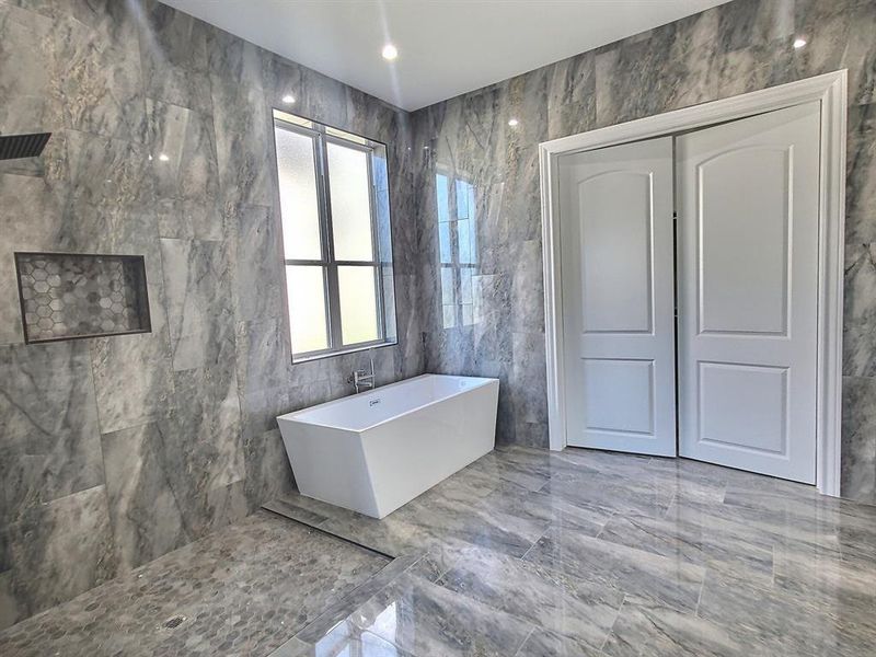 Bathroom with tile walls and a bath