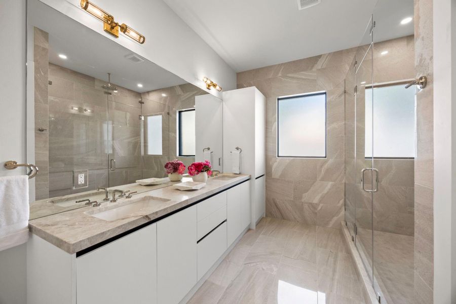Second Primary Bathroom includes dual vanities & large glass encased walk-in shower.