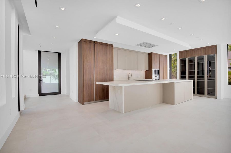 Entrance door and kitchen view from the living room. Entrance door and kitchen view from the living room.