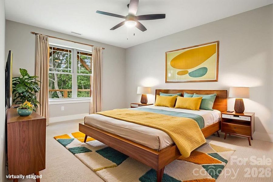 Lower level 3rd bedroom with ceiling fan and walk-in closet.