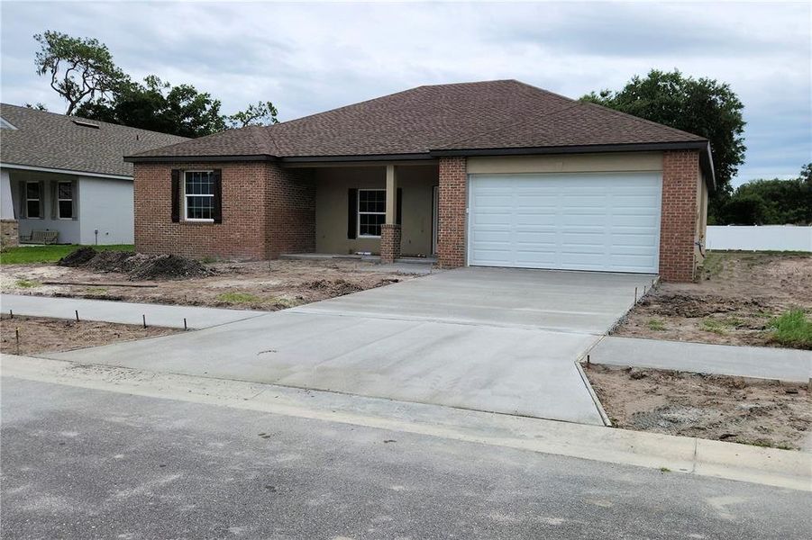 Front exterior of a new home in , Plant City, FL, highlighting curb appeal (Image 2). Front exterior of a new home in , Plant City, FL, highlighting curb appeal (Image 2).
