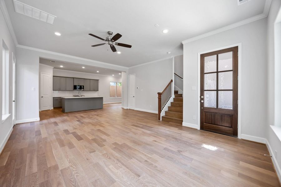 Open-concept goals. The transition from living to kitchen is effortless, with warm wood floors and clean lines that make everything feel connected and calm.